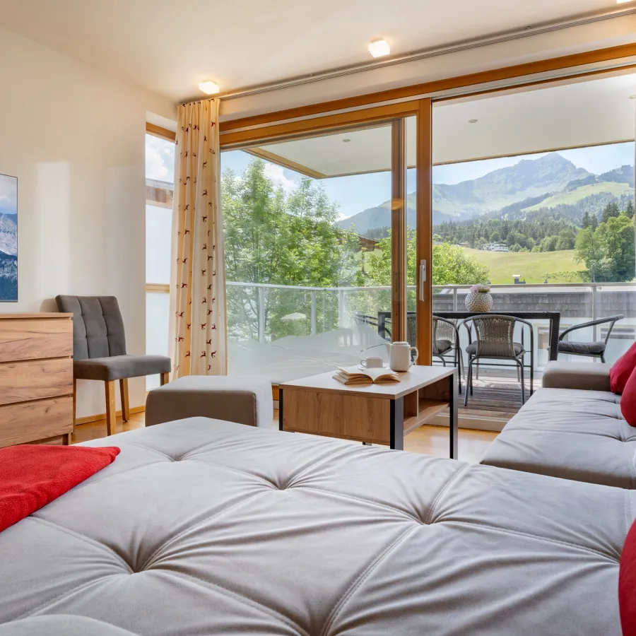 Wohnraum mit Ecksofa und Bergblick im Balkon-Apartment Top 26